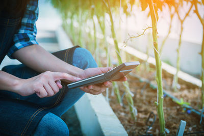 Midsection of man using mobile phone outdoors