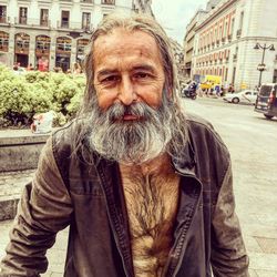 Portrait of man on street in city