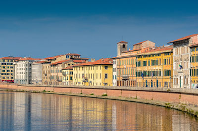 Buildings in city against blue sky