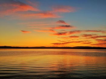 Scenic view of lake against romantic sky at sunset