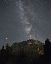 Scenic view of mountains against star field at night