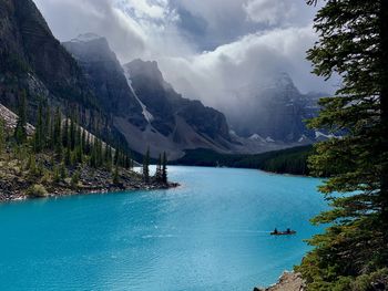 Scenic view of lake by mountains against sky