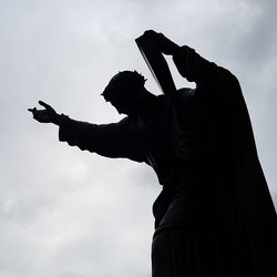 Low angle view of silhouette man against sky