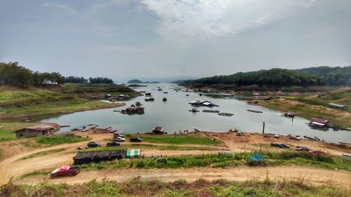 High angle view of land by lake against sky