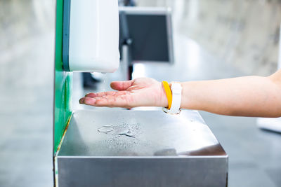 Cropped hand of person washing hands