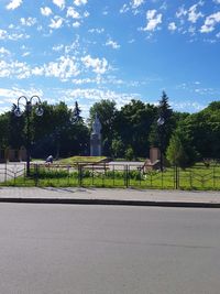 Empty road against trees