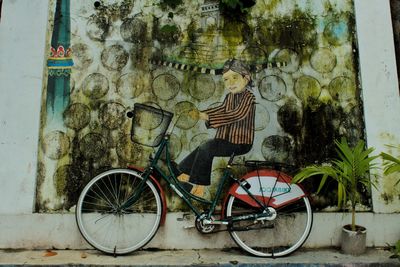 Bicycle against wall in city