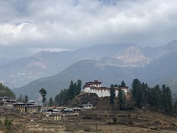 Scenic view of building against cloudy sky