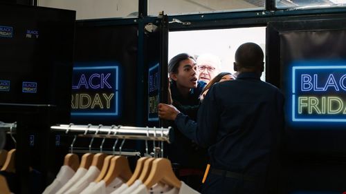 Rear view of man standing in store