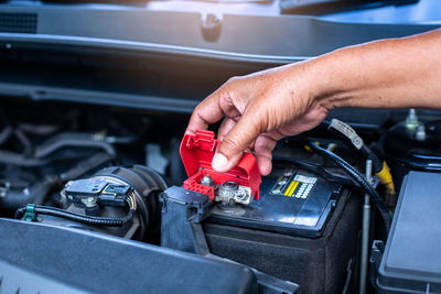 Cropped hand of man repairing car