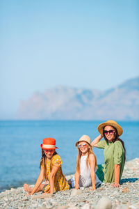 Portrait of people at beach against sky