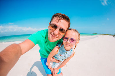 Portrait of father and son at beach