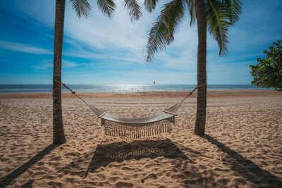 Relaxed moment  on hammock under the palm trees on the sunny beach