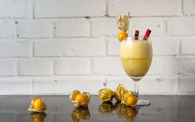 Close-up of drink on table against wall