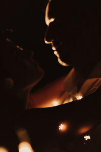 Close-up portrait of woman with illuminated lights