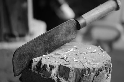 Close-up of knife on tree stump