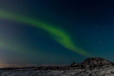 Low angle view of snowcapped mountain against sky at night