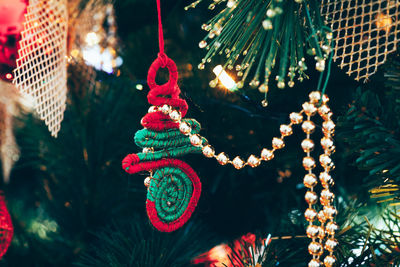 Close-up of illuminated christmas decorations on tree at night