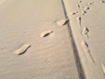 High angle view of footprints on sand at beach