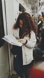 Woman standing by window