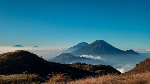 View of mountain range against blue sky