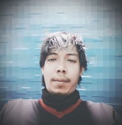 Portrait of young man against wall