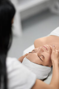 Midsection of woman lying down on floor