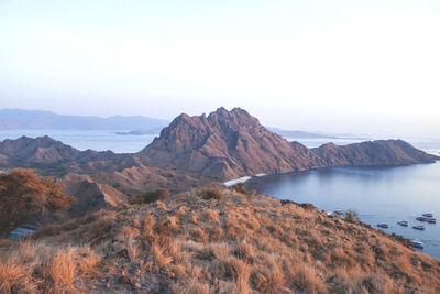 Scenic view of lake and mountains against clear sky