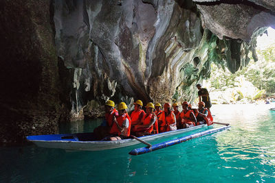 Group of people on rock in cave