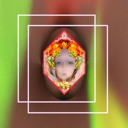 Directly above view of human face against colored background