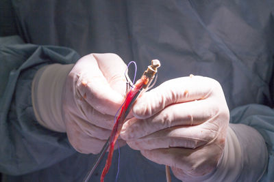 Midsection of doctor performing surgery at hospital