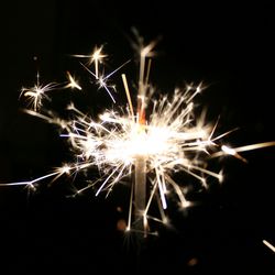 Low angle view of firework display at night