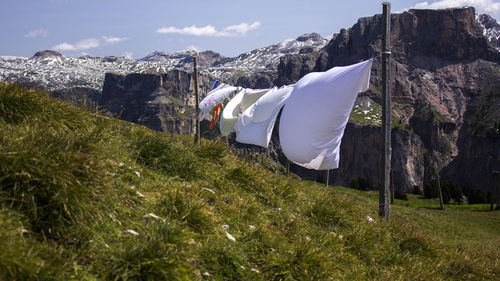 Panoramic shot of clothes drying on field against sky