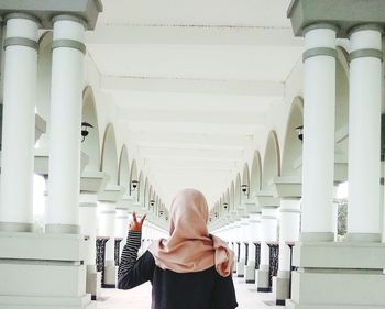 Rear view of woman standing in building