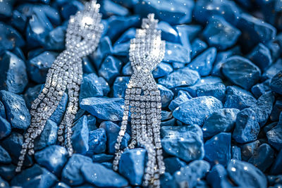 Close-up of diamond earrings on stones