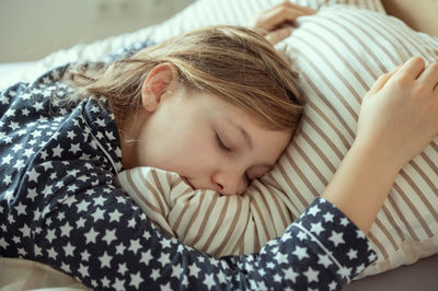 Cute girl sleeping on bed at home