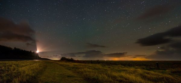 Scenic view of field against sky at night