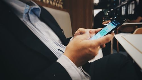 Close-up of man using mobile phone