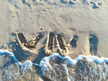 High angle view of text on sand