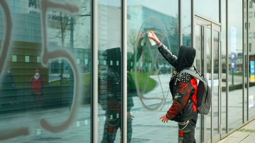 Reflection of woman in glass building