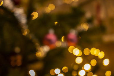 Defocused image of illuminated christmas tree at night