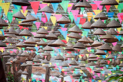 Low angle view of multi colored flags hanging for sale