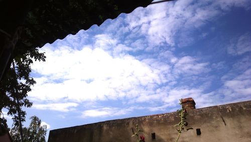 Low angle view of building against cloudy sky