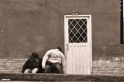 Rear view of people outside building