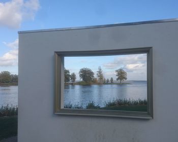 Reflection of trees on lake against sky