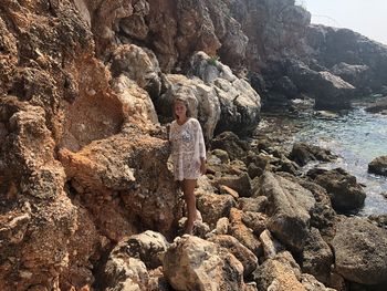 Full length of woman standing on rock