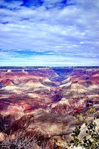 Aerial view of dramatic landscape against cloudy sky