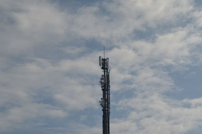 Low angle view of communications tower against sky