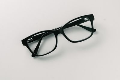 Close-up of sunglasses on table against white background