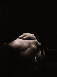 Close-up of hands over black background